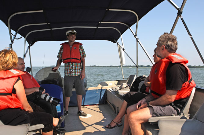 The captain of theRandonnée nature speaks to passengers during a tour of the archipelago. 