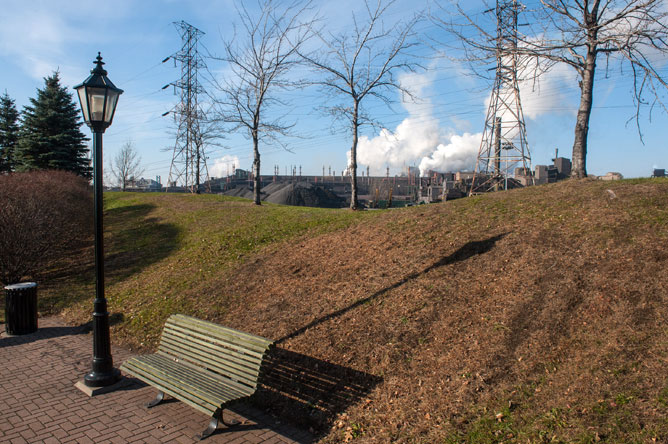 Lamppost, park bench and the smokestacks of Rio Tinto Fer et Titane seen from Ilmenite Park