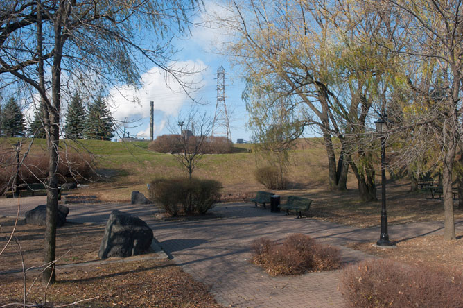 Willow, spruce, ilmenite blocks and the smokestacks of Rio Tinto Fer et Titane seen from Ilmenite Park