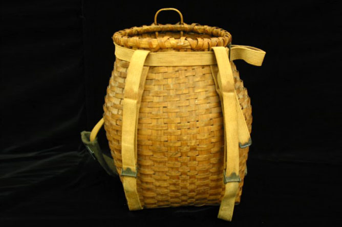 Ash fishing basket with straps, used to carry fish.