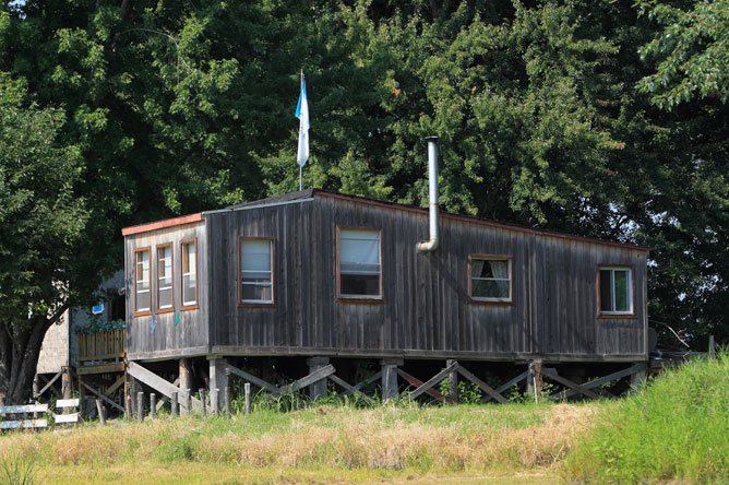 Grey wooden cabin on stilts