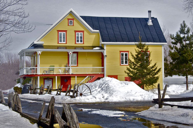 Yellow and orange house on Île d'Embarras, built in the 19th century