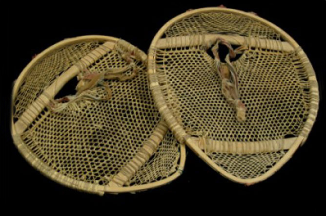 Pair of bearpaw snowshoes with rawhide lacing 