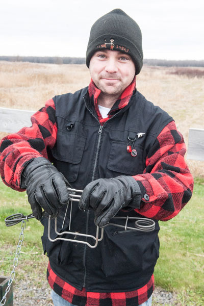 Man holding a trap.