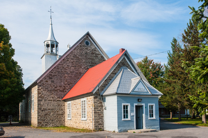 Small stone church with a red roof, built in 1828