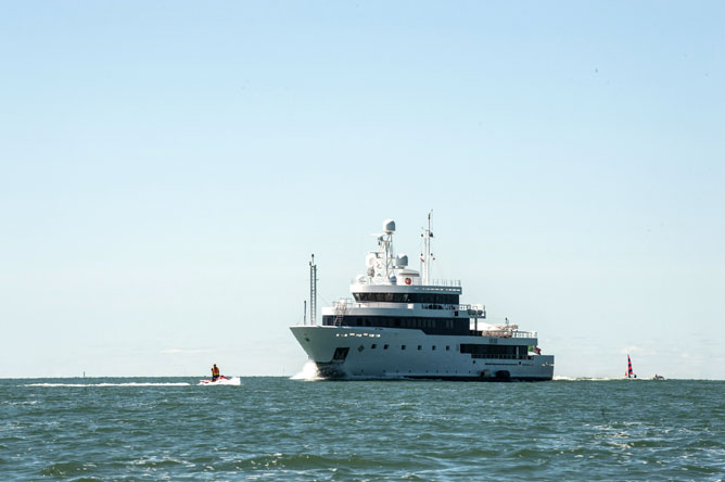 Large white ship, personal watercraft and sailboat on Lake Saint-Pierre