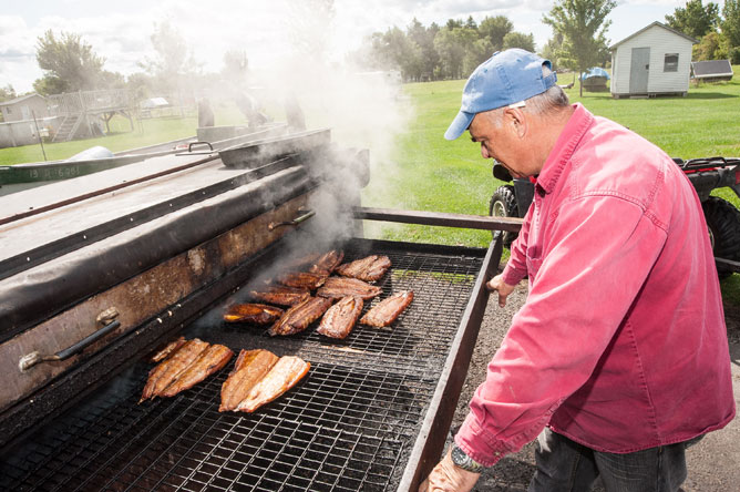 Commercial fisherman in front of his smoker