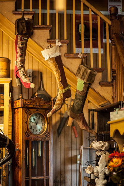 Wooden staircase and antique clock inside the Magasin général Le Brun